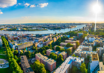 Wall Mural - Beautiful view of famous Hamburger Landungsbruecken and industrial port on Elbe river in Hamburg, Germany