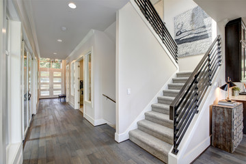 hallway features a staircase with gray carpet runner