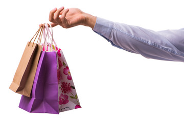 Hand holding shopping bags with christmas shopping on white back