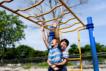 Young asian boy hang  out door playground