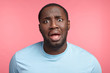 © wayhome.studio  - Portrait of sorrorful dark skinned man looks with frustrated expression, widely opened eyes and mouth, regrets his actions, isolated over pink background. People, ethnicity, facial expressions