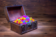 Opened Chest Treasure With Jewel Decoration Over Wooden Background, Close Up
