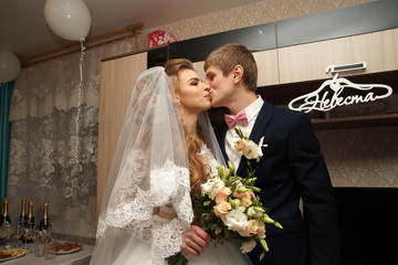 Beautiful young bride posing in a wedding dress