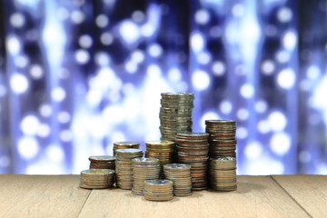 Coin stack with blur light dreamy bokeh background. Business, finance and saving concept.