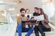 © Mediteraneo - Happy group of friends sitting on the stairs in the school or college
