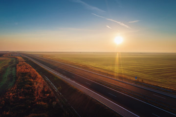 Wall Mural - Aerial view of highway with forest and fields in fog