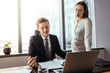 © Jacob Lund - Businessman reading and discussing contract with colleague