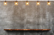 canvas print picture - Empty brown wood plank board shelf at grunge concrete wall with light bulb string party background,Mock up for display or montage of product or design