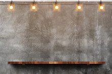 Empty Brown Wood Plank Board Shelf At Grunge Concrete Wall With Light Bulb String Party Background,Mock Up For Display Or Montage Of Product Or Design