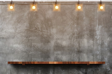empty brown wood plank board shelf at grunge concrete wall with light bulb string party background,m