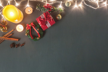 Wall Mural - Table top view image of Christmas decoration & Ornament Happy new year background concept.Lighting & Candle withe essential items for season on modern grunge grey wooden at home office desk with space