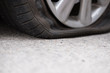 © 88studio - Car tire leak because of nail pounding. flat tyre on road. Flatten punctured wheel