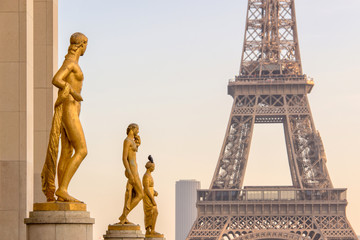  Golden bronze statues on Trocadero square, Eiffel tower in the background, Paris France
