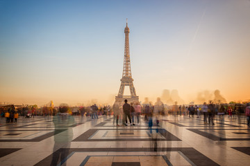 Poster - Blurred people on Trocadero square admiring the Eiffel tower at sunset, Paris, France