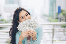 Successful Beautiful  Asian Business  Young Woman Holding Money US Dollar Bills In Hand , Business Concept