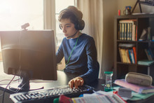 Teenager Playing At Computer Game