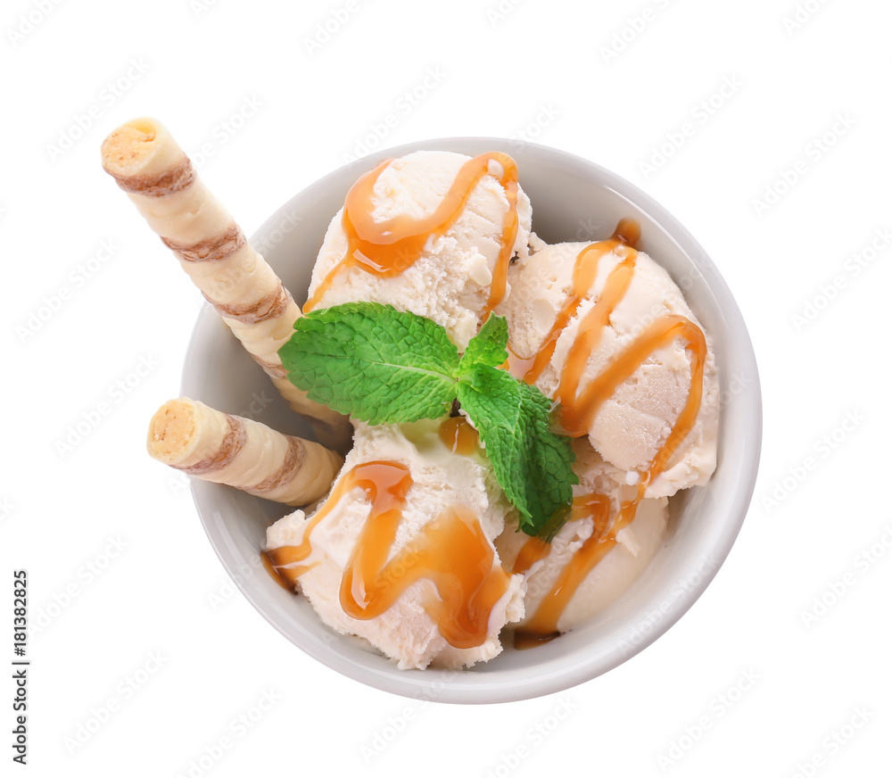 Bowl with caramel ice cream on white background