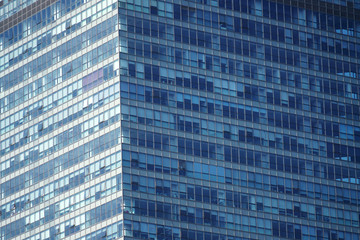 Wall Mural - close up on modern office building skyscraper with blue glass wall