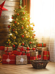 interior christmas. magic glowing tree, fireplace, gifts