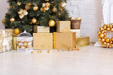 Photo Of Luxury Gift Boxes Under Christmas Tree, New Year Home Decorations, Golden Wrapping Of Santa Presents, Festive Tree Decorated With Garland, Baubles, Traditional Celebration. Copy Space