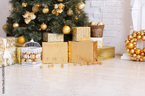 Photo Of Luxury Gift Boxes Under Christmas Tree New Year Home Decorations Golden Wrapping Of Santa Presents Festive Tree Decorated With Garland Baubles Traditional Celebration Copy Space Buy This Stock Photo