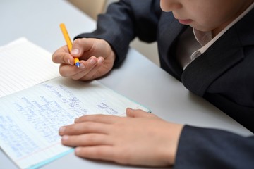 Selective focus of little boy learning how to write his name, Kid study at home, Children do homework at home, Concept for toddler learn about writing the letter or message