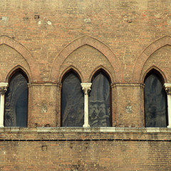 Sticker - arch window at medieval brick building in the historic center of Siena, Italy.