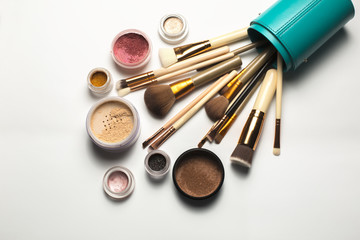 Sticker - Set of cosmetic brushes, bronzer, eyeshadow in a case on a white background