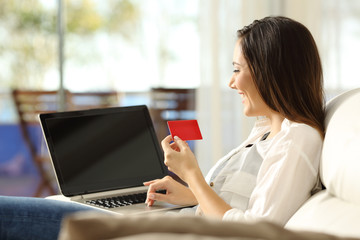 Wall Mural - Woman paying on line with a credit card