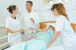© auremar - nurse rolling patient over in hospital bed