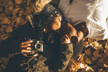 Wall Mural - Young african couple have fun in the autumn forest.