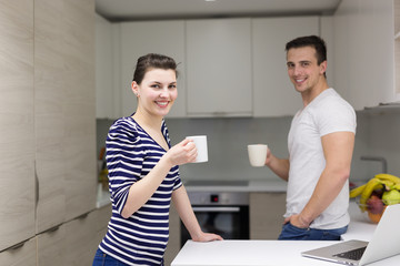 Wall Mural - couple with laptop computer enjoying morning