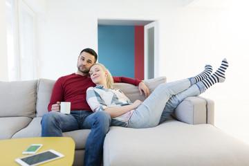 Wall Mural - couple hugging and relaxing on sofa