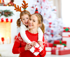 Poster - happy family mother and daughter giving christmas gift .