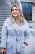 © T.Den_Team - A woman of plus size, American or European appearance walks in the city enjoying life. A young lady with excess weight, stylishly dressed in coat at the center of the city. Natural beauty