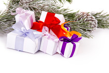 A Set Of Christmas Gifts Under Fir Branches On White Background