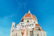Hand written lettering card in girl's hand with word Florence in front of Florence duomo. Travel Italy inspiration!