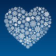 vector heart made of little snowflakes on blue background