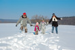 © Iuliia Sokolovska - Happy family walks in winter, having fun and playing with snow outdoors on holiday weekend