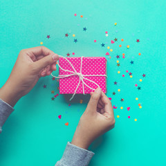 Wall Mural - A girl decorating cute gift box .celebration anniversary and party concepts