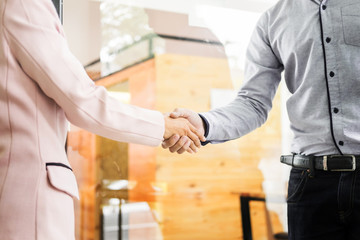 Wall Mural - Two confident business man shaking hands during a meeting in the office, success, dealing, greeting and partner concept