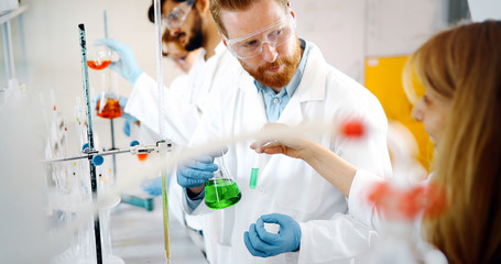 Young students of chemistry working in laboratory