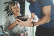 © SFIO CRACHO - Coworkers working process at home.Young blonde woman working together with bearded colleague man at modern home office.People using electronic devices.Blurred background.Horizontal.