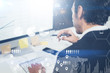 © SFIO CRACHO - Concept of digital diagram,graph interfaces,virtual screen,connections icon.Portrait of young businessman working at modern office.Blurred background.Horizontal.Cropped.
