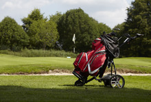  Golf Bag With Several Clubs On A Trolley On The Fairway Of A Golf Course