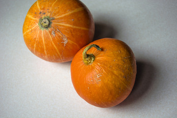 Two pumpkins on white top