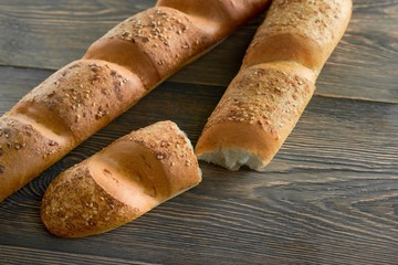 Two delicious fresh baguettes on wooden table copyspace food eating nutrition french cusine pastry baking bakery groceries breakfast organic natural concept.