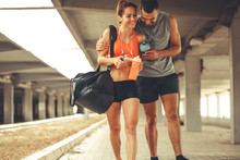 Young Couple Walking On Street In Sports Wear.They Going To Gym.