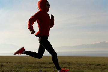 Fitness woman runner running on country road