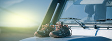 Trekking Shoes Are Drying On A Dirty 4wd Car Bonnet
